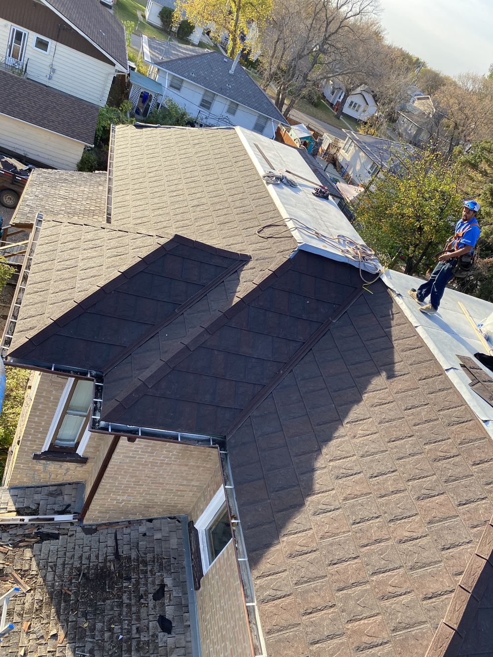 Close-up of roofing shingles being worked on
