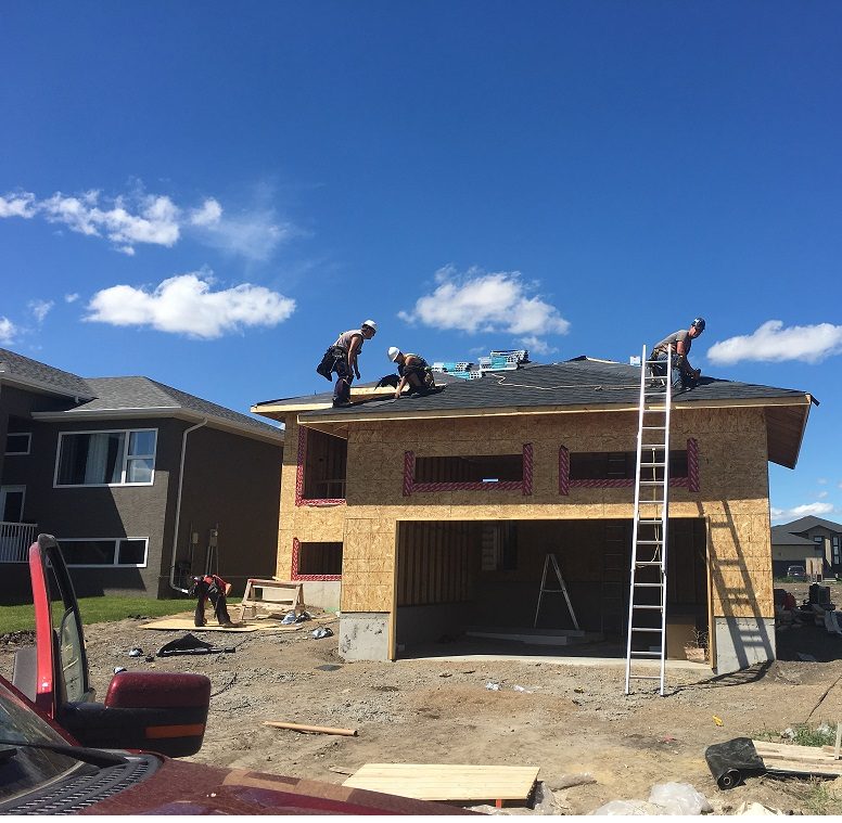 DT Roofing crew shingling a new build