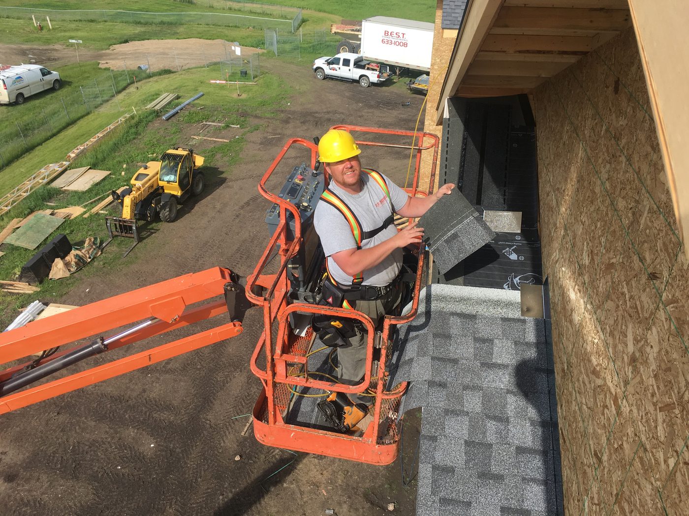 Owner Drayson Tousignant installing shingles on a Westman roof