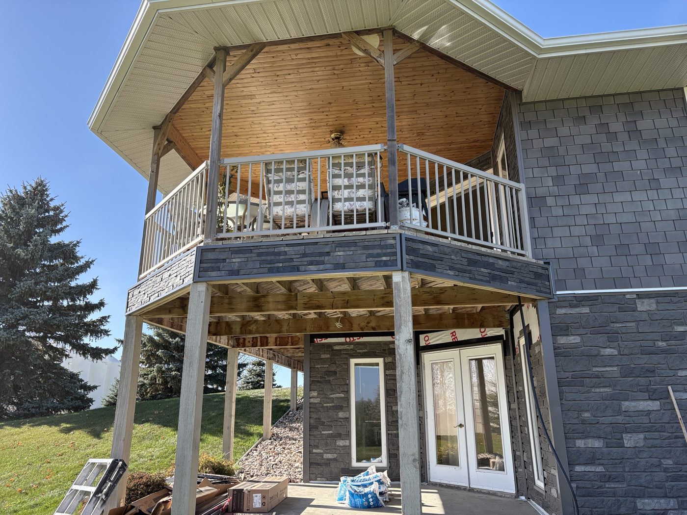 Stone siding and cedar soffit under a deck