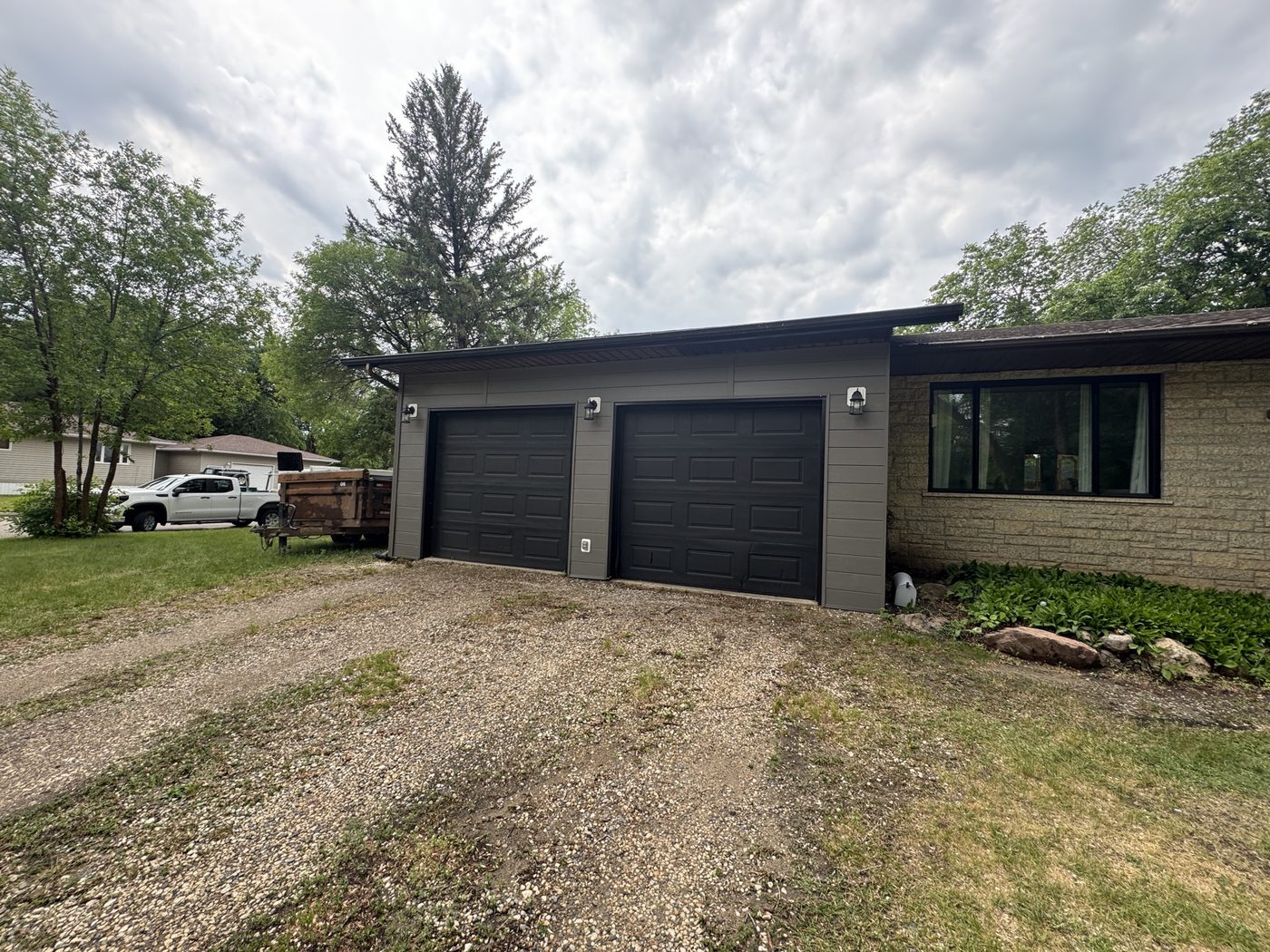 Dark siding and stone on a modern garage