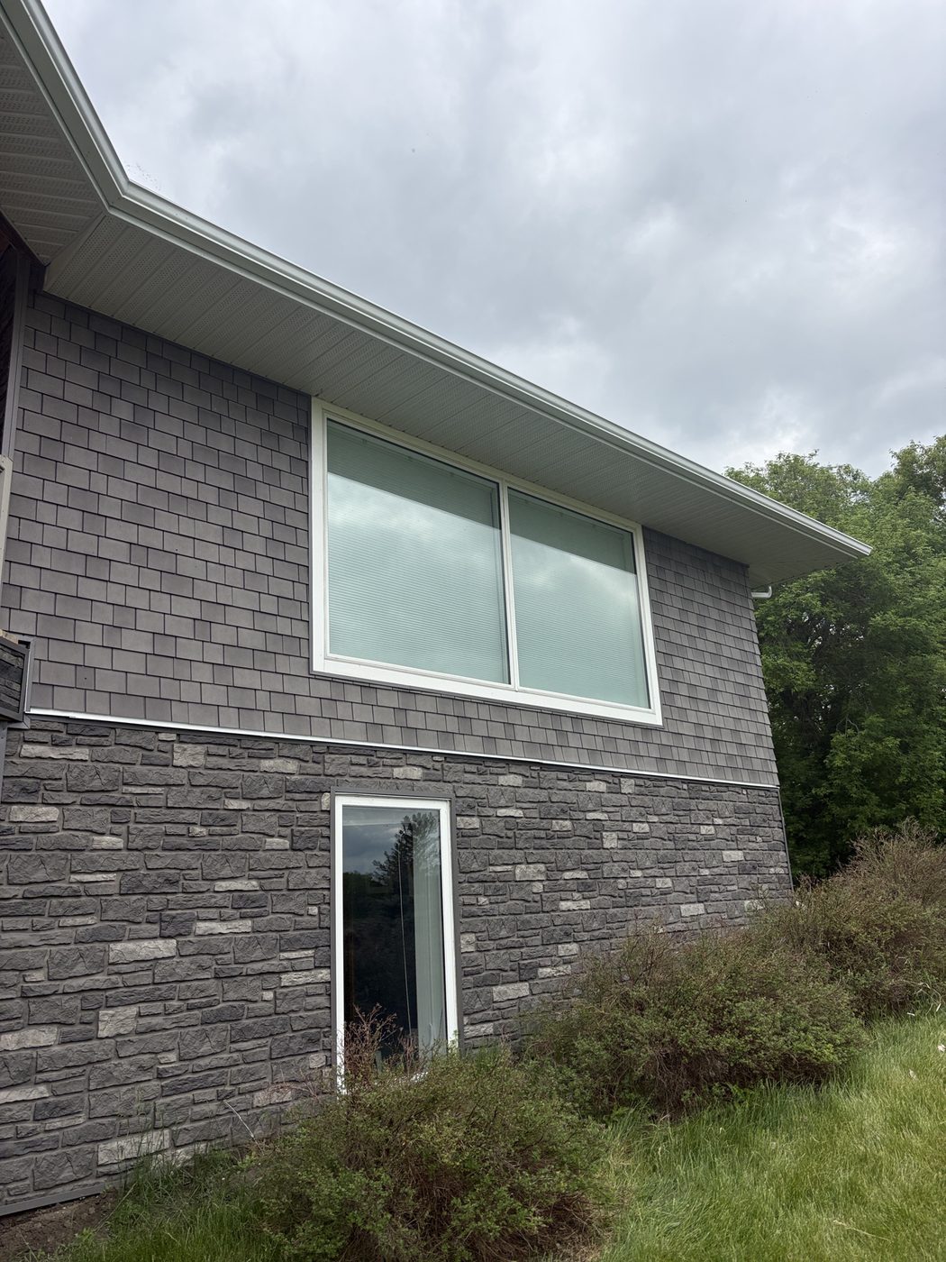 Shake siding and stone on a Westman home