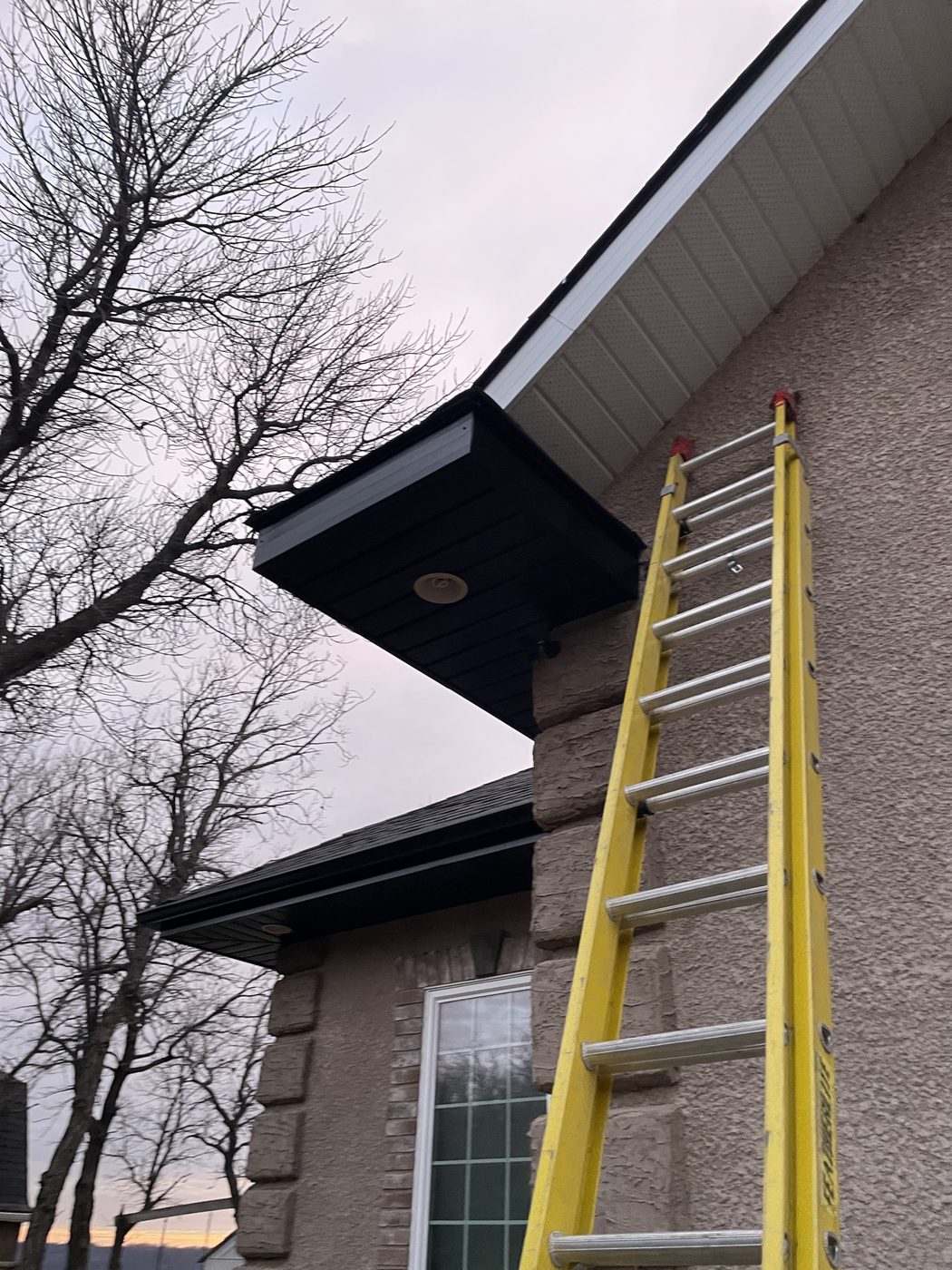 Dark fascia and eavestrough colour change on a home