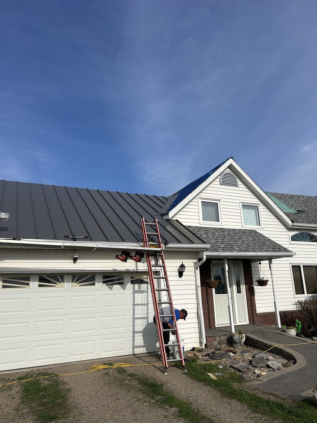 Standing-seam metal roof being installed